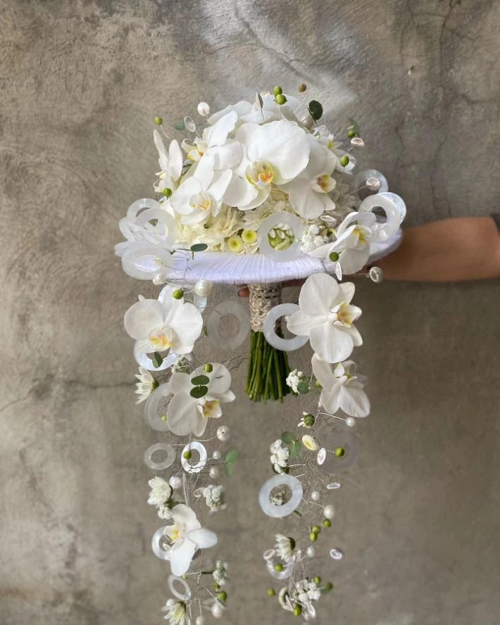 Avant-garde white orchid bouquet with pearl and sculptural details