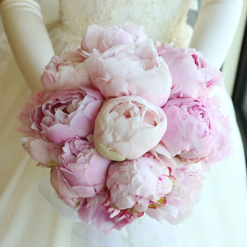 Rounded bridal bouquet of soft pink peonies