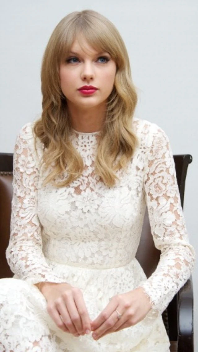 Taylor Swift in an elegant white lace gown