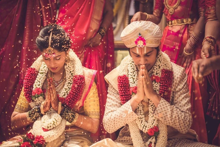 Indian wedding couple beside a sacred ceremonial fire