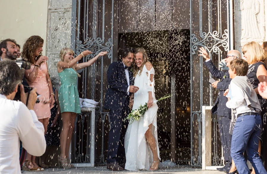 Newlyweds showered with rice outside an Italian church