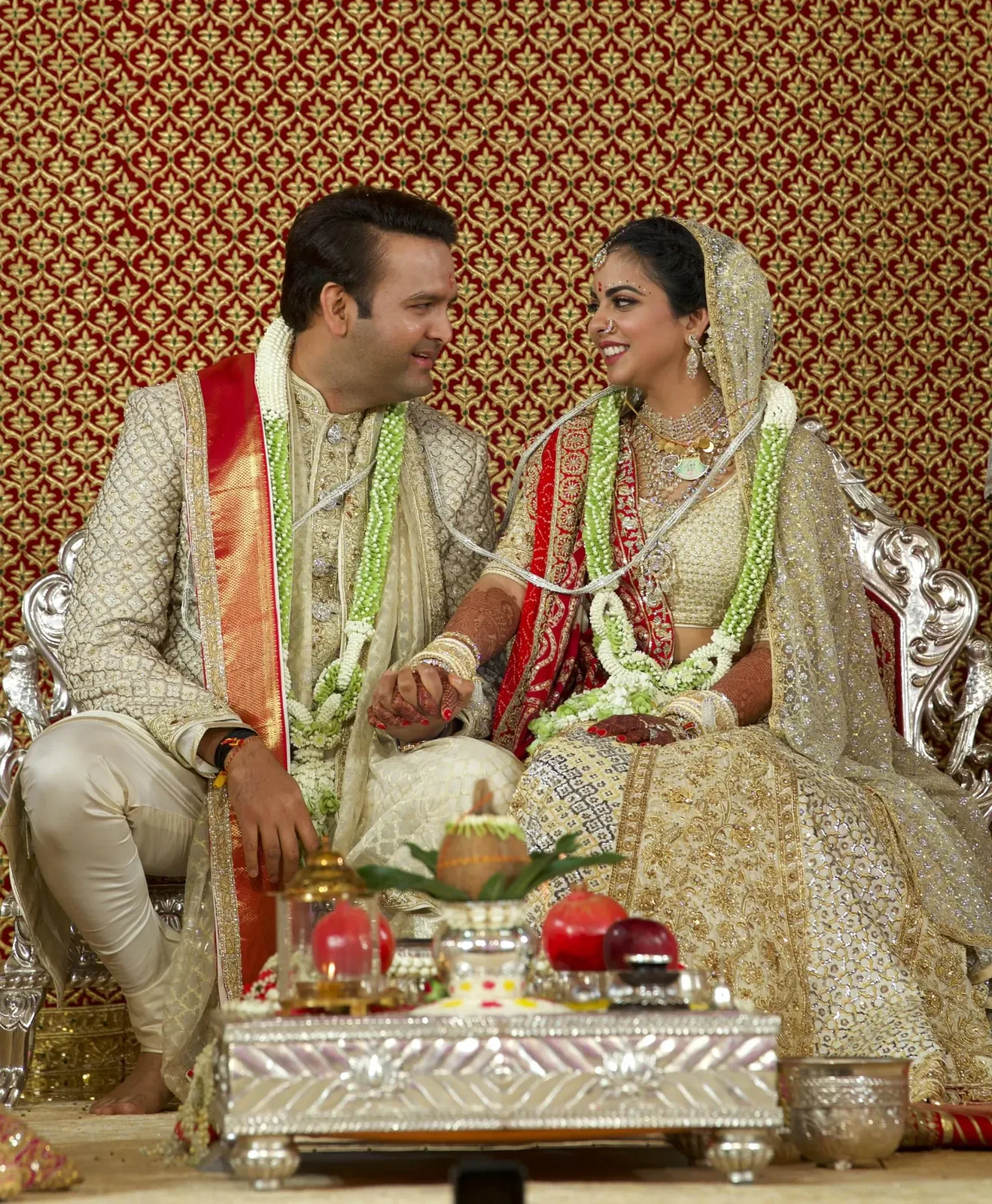 Isha Ambani and Anand Piramal seated together at their 2018 wedding