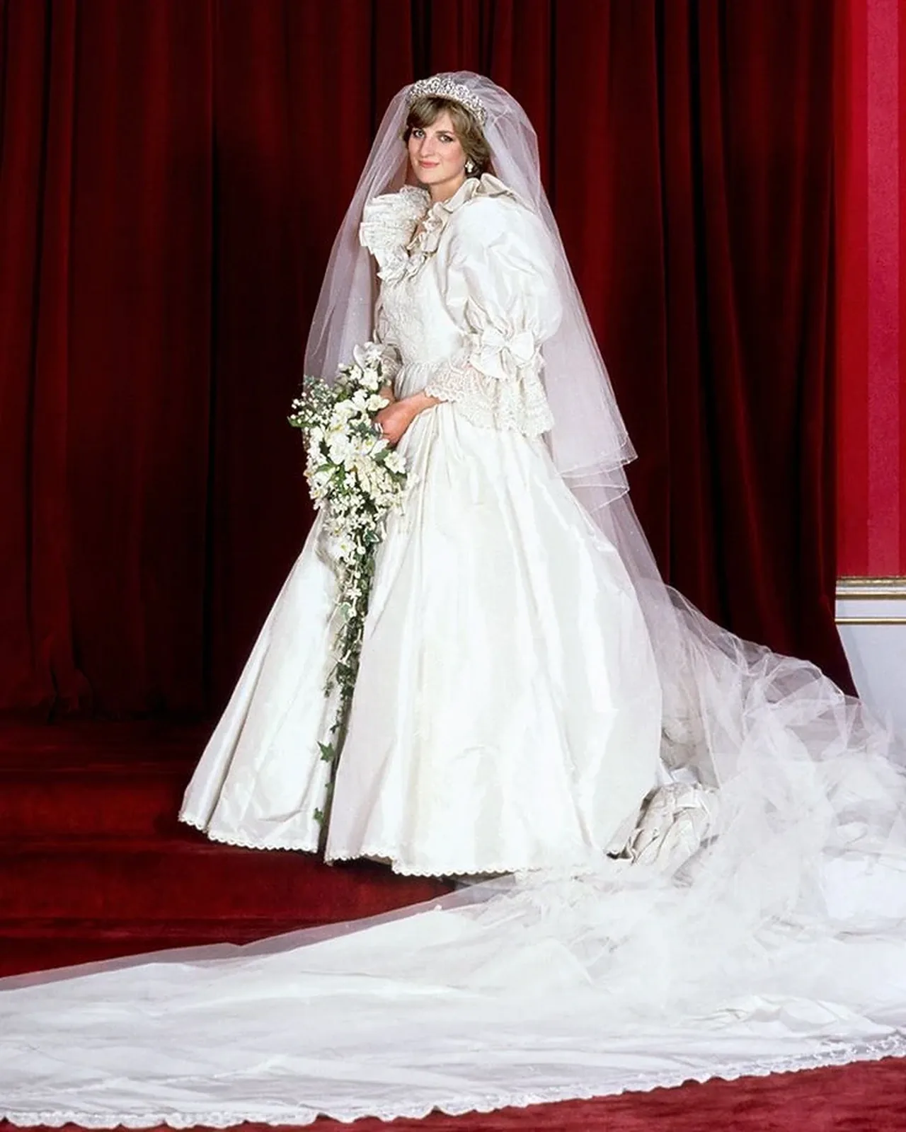 Princess Diana in her ivory silk taffeta wedding dress with its long train
