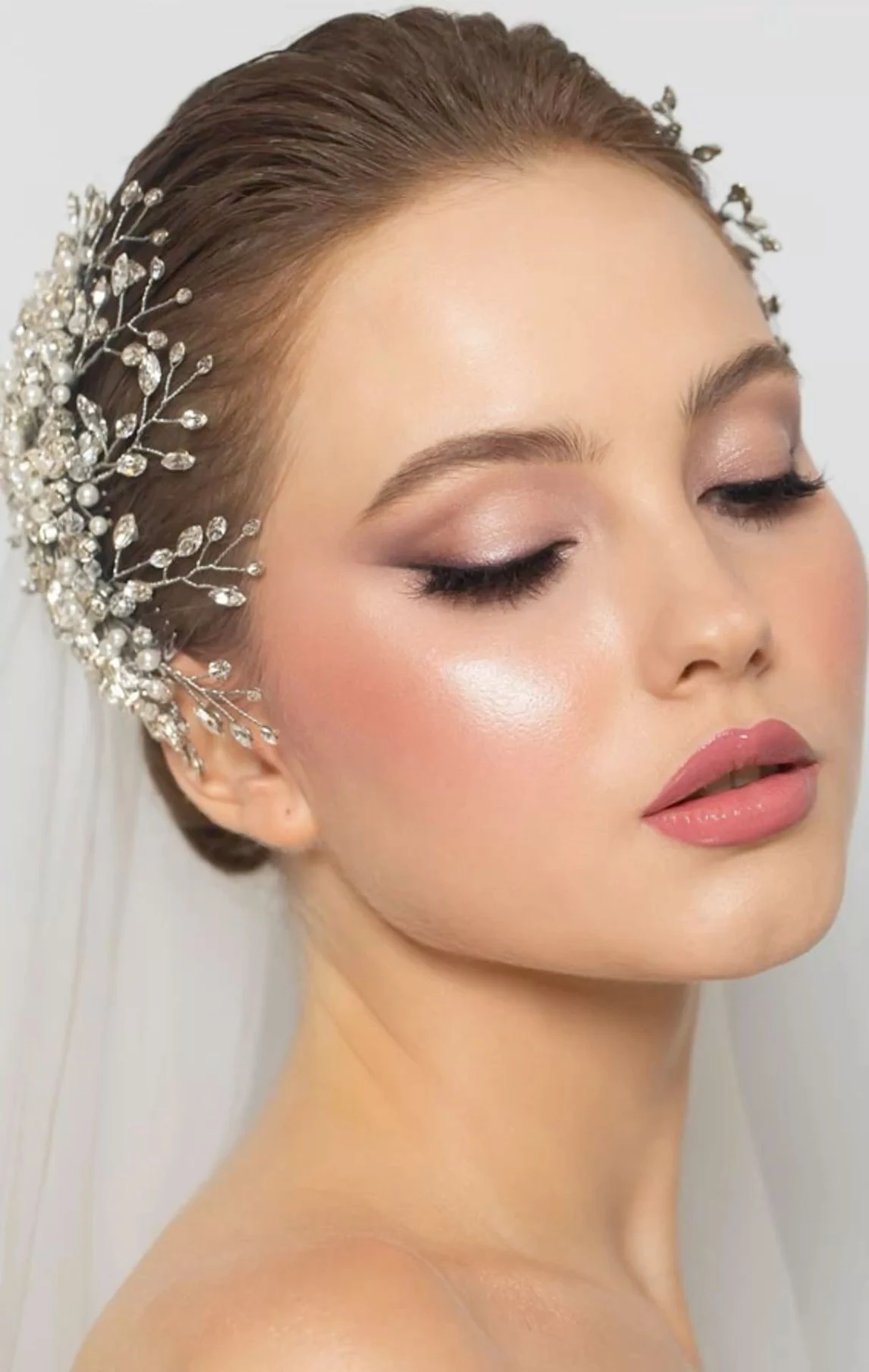 Bride wearing luminous soft-glam makeup with rosy eyes and lips