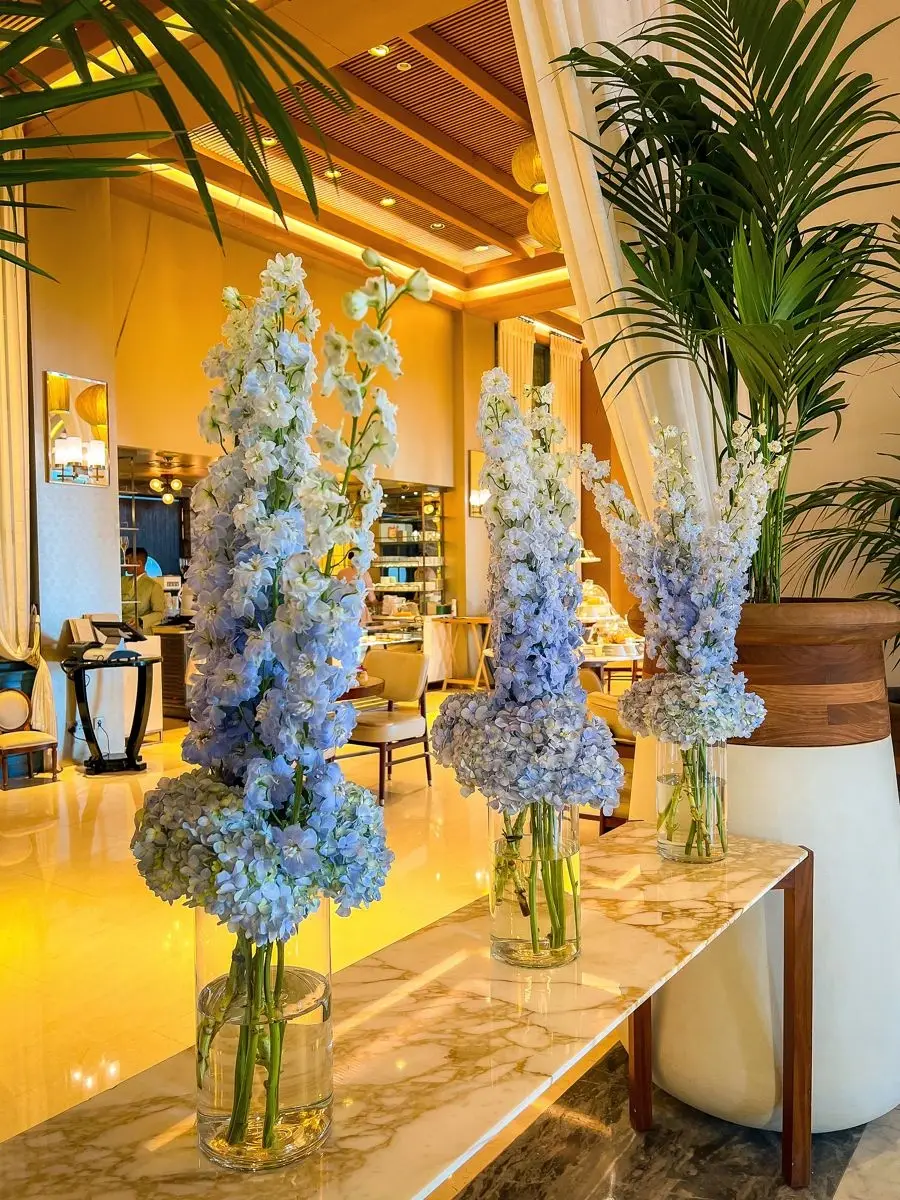 Airy blue floral installation at an event entrance