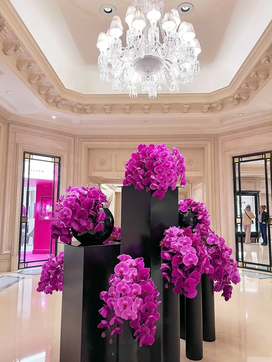 Pink orchid arrangements on black mirrored plinths