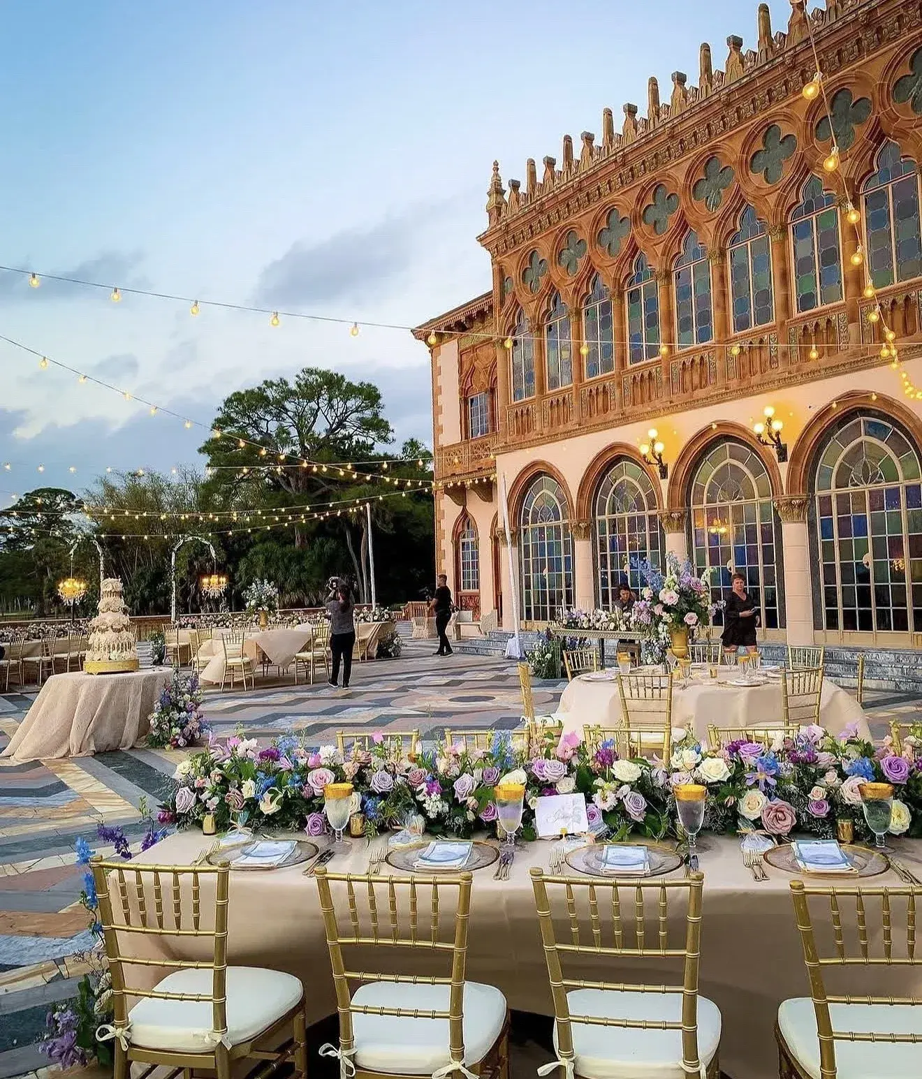 Outdoor wedding reception in Florida, with floral tables and string lights