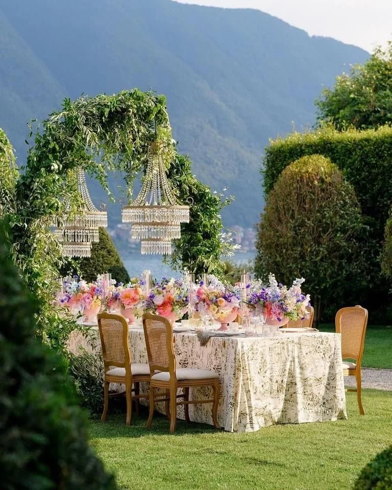 Garden wedding table with colorful florals and crystal chandeliers