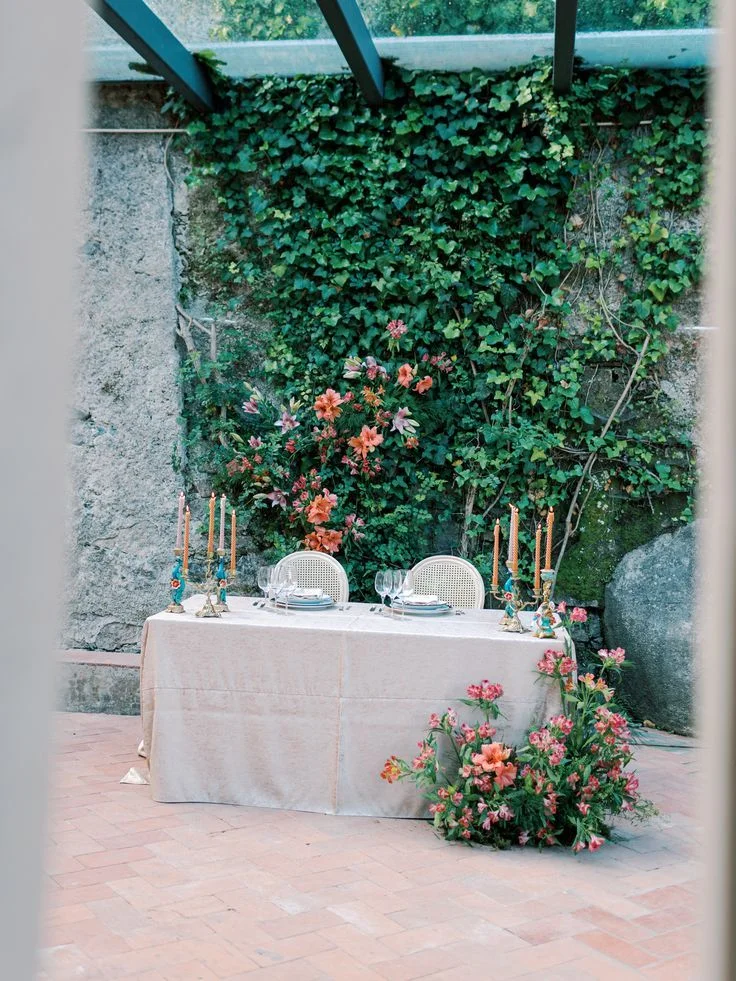 Intimate wedding table in an ivy-covered stone courtyard